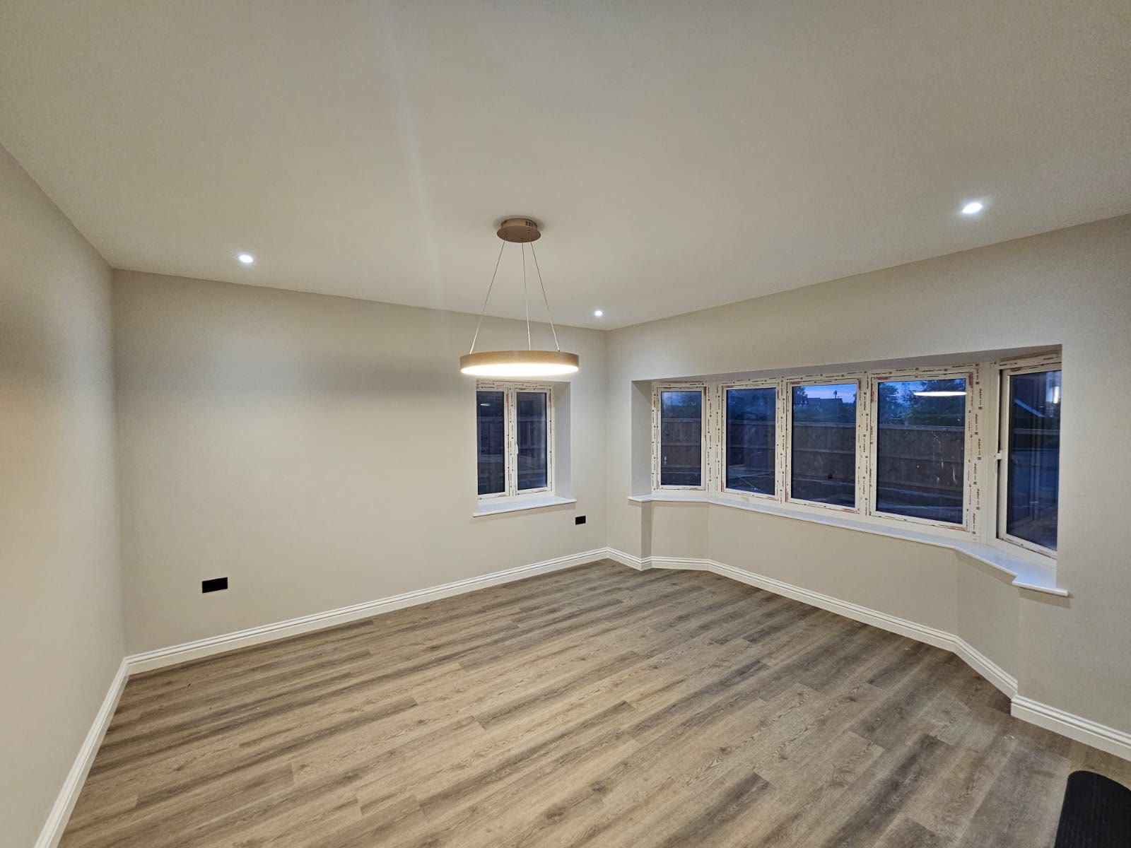 A finished lounge with smooth plastered walls and ceiling