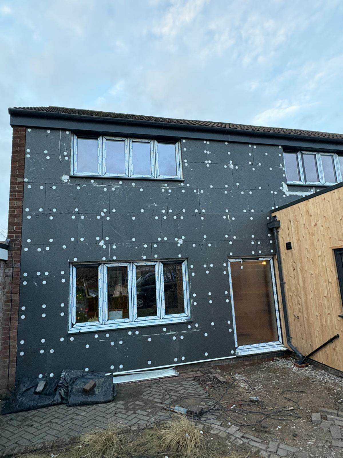 Insulation boards bonded and mechanically fixed to a front elevation, ready for basecoat and mesh